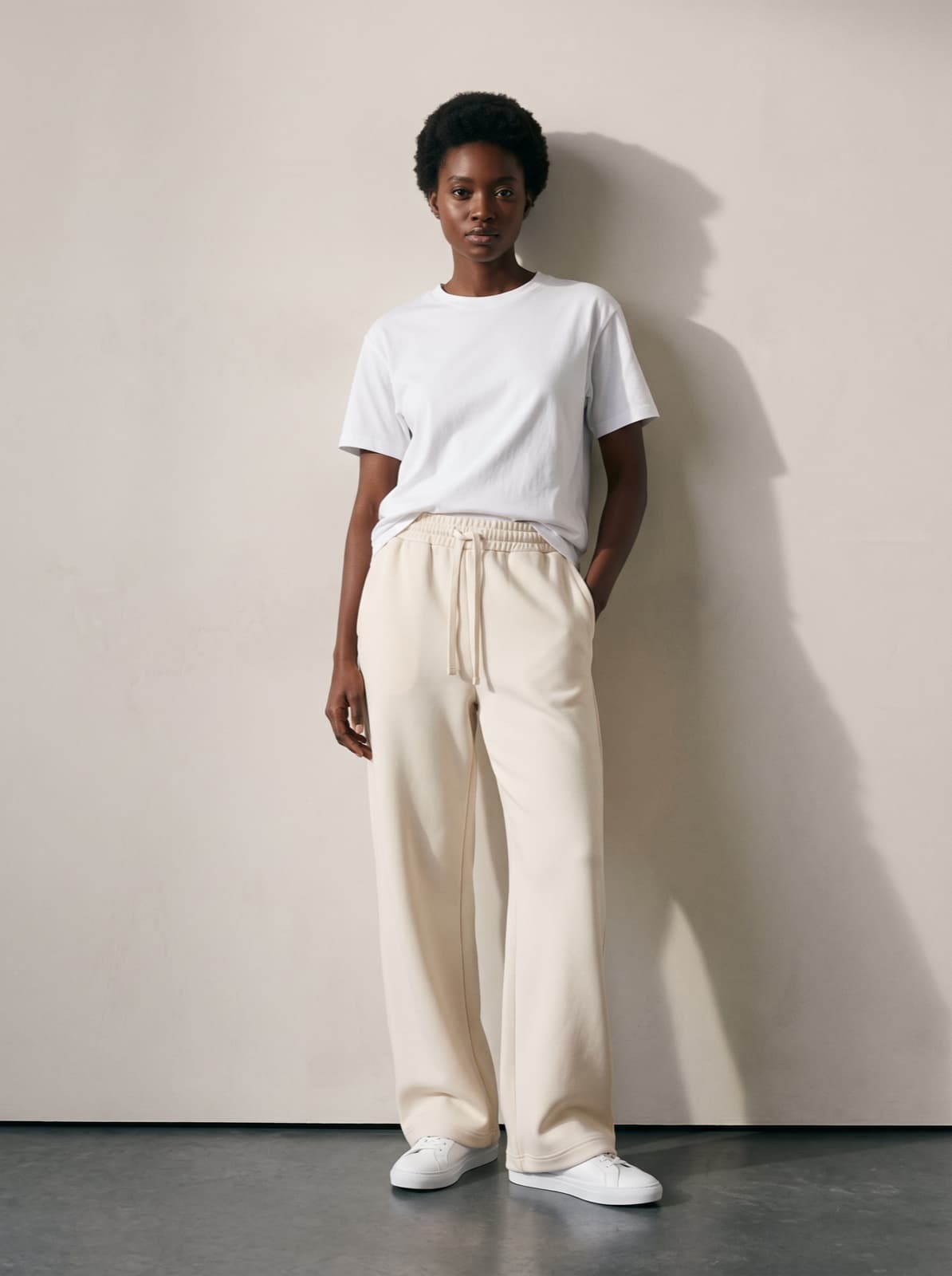 Chelsea Joggers in cream worn with a plain white tee, showing the flat drawcord