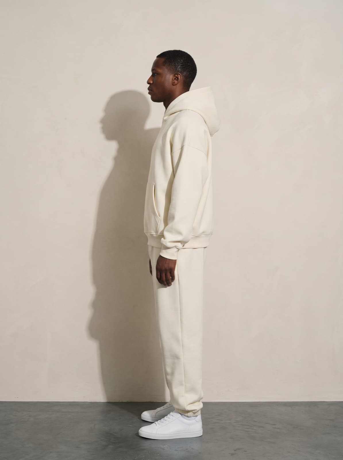 A model wearing the Chelsea Pullover and joggers in cream