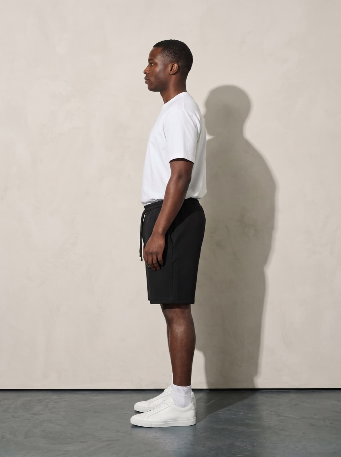 Side profile of the Chelsea Shorts in black showing the length