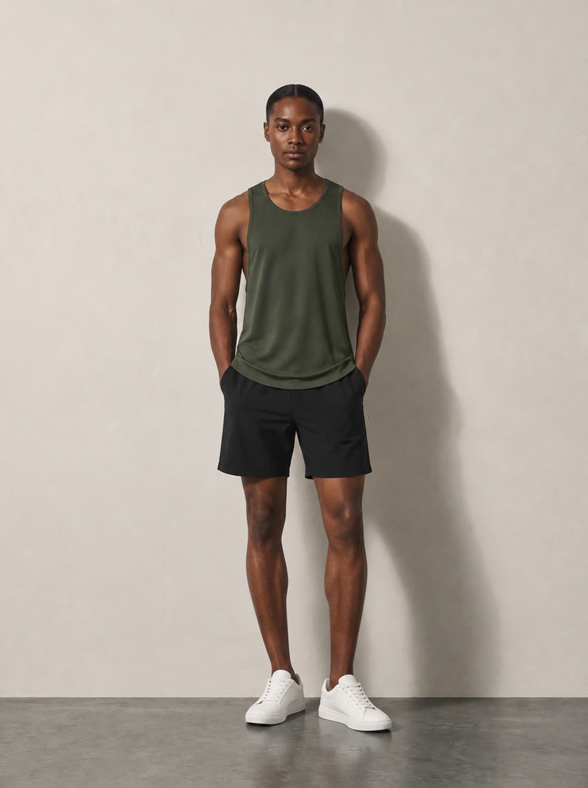 Current Training Tank in olive, worn with black training shorts