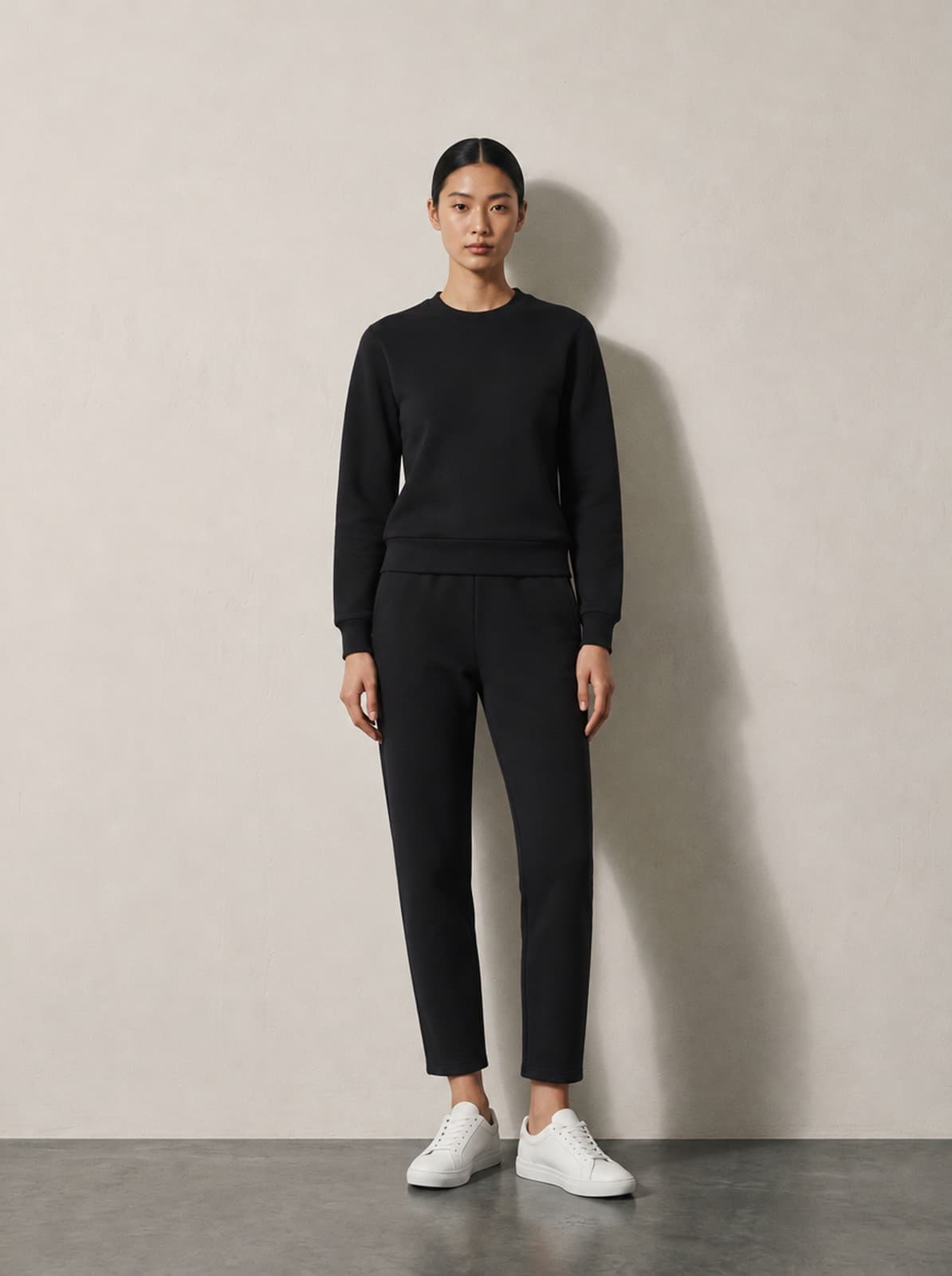 Marylebone Tracksuit in off black worn as a set, showing the closer cut through the chest and waist